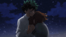 a boy and a girl are hugging each other in the dark