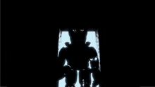 a silhouette of a robot with glowing eyes is standing in a dark room