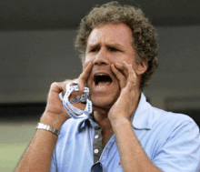 a man with curly hair is holding a measuring tape in his mouth