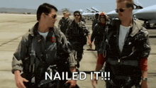 a group of military men are walking down a runway and one of them is saying `` nailed it ! ''