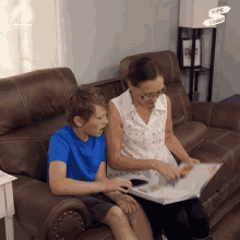 a woman sits on a couch reading a book to a young boy with a sign that says wife swap in the background