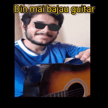 a man wearing sunglasses and a blue shirt is playing a guitar with the words din mai bajau guitar above him