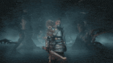 a woman in armor stands in front of a bear