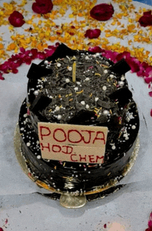 a chocolate cake with a sign that says pooja hoj chem