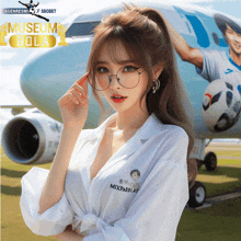 a woman wearing glasses is standing in front of an airplane that says museum bola on it