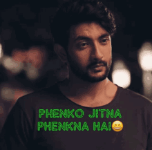 a man with a beard is wearing a black shirt that says phenko jitna phenkna hai on it