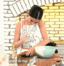 a woman in an apron is preparing food in a kitchen with the words " do n't do that " on the bottom