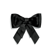 a black satin bow with a chanel logo on it