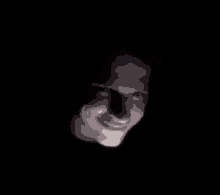 a close up of a man 's face in the dark