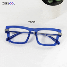 a pair of blue glasses with the word yahia on the top