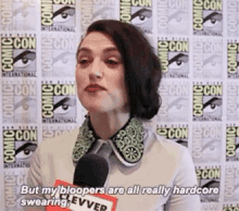 a woman is talking into a microphone at comic con and says `` but my blogs are all really hardcore swearing . ''