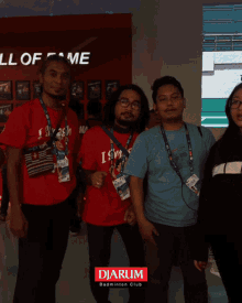 a group of people are posing for a picture in front of a wall that says " hall of fame "