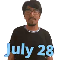 a man wearing glasses and a black shirt with the date july 28 on it