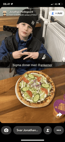 a young boy is sitting at a table with a pizza on it