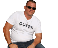 a man wearing sunglasses and a white guess t-shirt