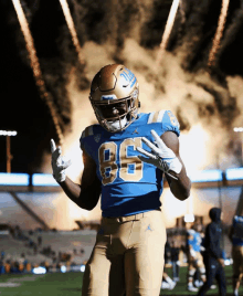 a football player wearing a blue uniform with the number 86 on it