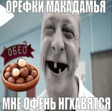 a picture of a man with a bowl of macadamia nuts in front of him