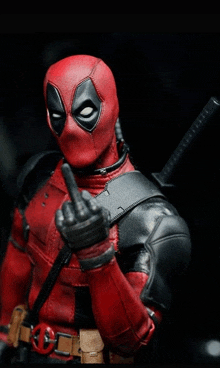 deadpool is giving the middle finger and has a sword in his right hand