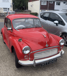 a red car with a license plate that says htt104d