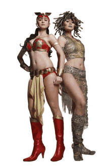 two women dressed in costumes are standing next to each other on a white background .