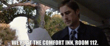 a man in a suit and tie says we 're at the comfort inn room 112 ..