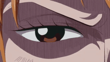 a close up of a person 's eye with a slight smirk on their face