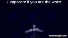 a creepy doll is taking a selfie with her arms outstretched in a dark room .