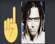 a black and white photo of a man wearing glasses and dreadlocks next to a yellow finger .