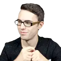 a man wearing glasses and a black shirt looks at the camera
