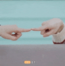 two people are holding each other 's hands and pointing at each other .