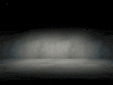 an empty room with a concrete floor and a concrete wall