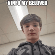 a young boy taking a selfie with a caption that says ninfo my beloved