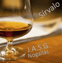 a glass of j.a.s.g. nogallas sits on a wooden table