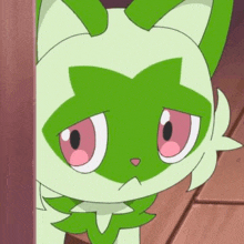 a green and white cartoon cat with pink eyes is peeking out from behind a wall .