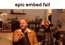 two men are sitting on a couch with epic embed fail written on the bottom