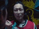 a man with a ring on his finger is holding a toy sword