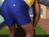a man in blue shorts is standing on a green mat in a living room .