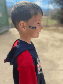 a young boy with the word elite on his face