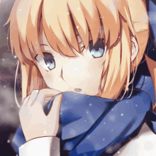 a girl with blonde hair and blue eyes wearing a blue scarf around her neck