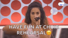 a woman is singing into a microphone with the words `` have fun at choir rehearsal '' next to her .