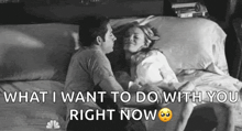 a man and a woman are laying on a bed and the man is kissing the woman .