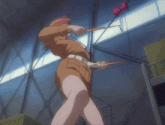 a woman in a brown skirt is holding a stick in her right hand