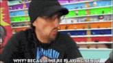 a man wearing a black shirt that says why because we re playing bendy