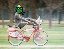 a man in a suit is riding a bicycle with a pixelated face on his head