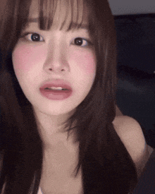 a close up of a woman 's face with a slight smile on her face