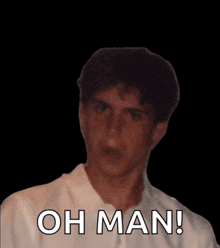 a man in a white shirt says " oh man " in front of a black background