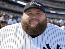 a man with a beard wearing a evil empire hat