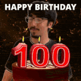 a man is blowing out candles on a cake with the number 100 on it .