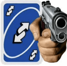 a person is holding a gun in front of a blue uno card