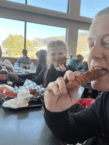 a man and a little girl are eating chicken nuggets